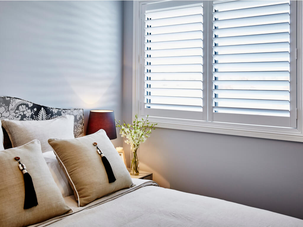 Frederick, CO 3 window shutters in bedroom | Custom Window Treatments in Longmont , CO