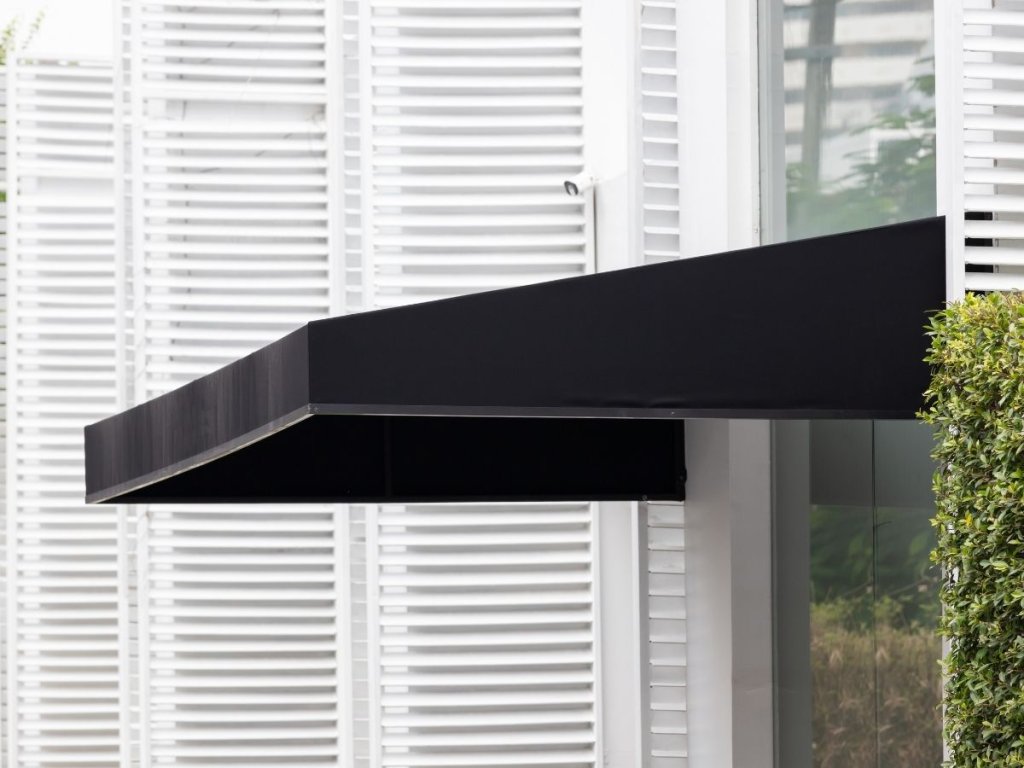 A black awning over a glass front door